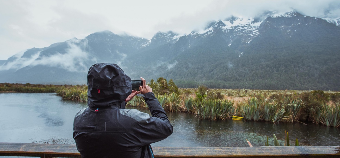 Taking photos at the famous Mirror Lakes stop on the Milford Road