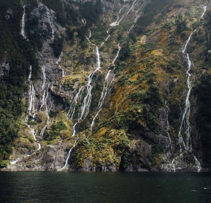 Many temporary waterfalls appear on the cliffs around Piopiotahi / Milford Sound after heavy rain 