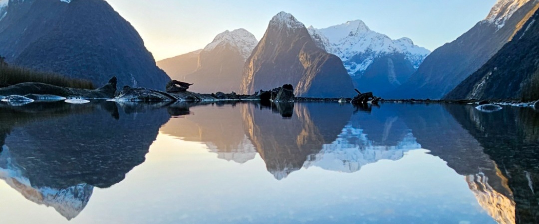 A beautiful reflection of Mitre Peak in the water of the Milford Sound foreshore