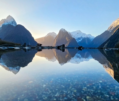 A beautiful reflection of Mitre Peak in the water of the Milford Sound foreshore